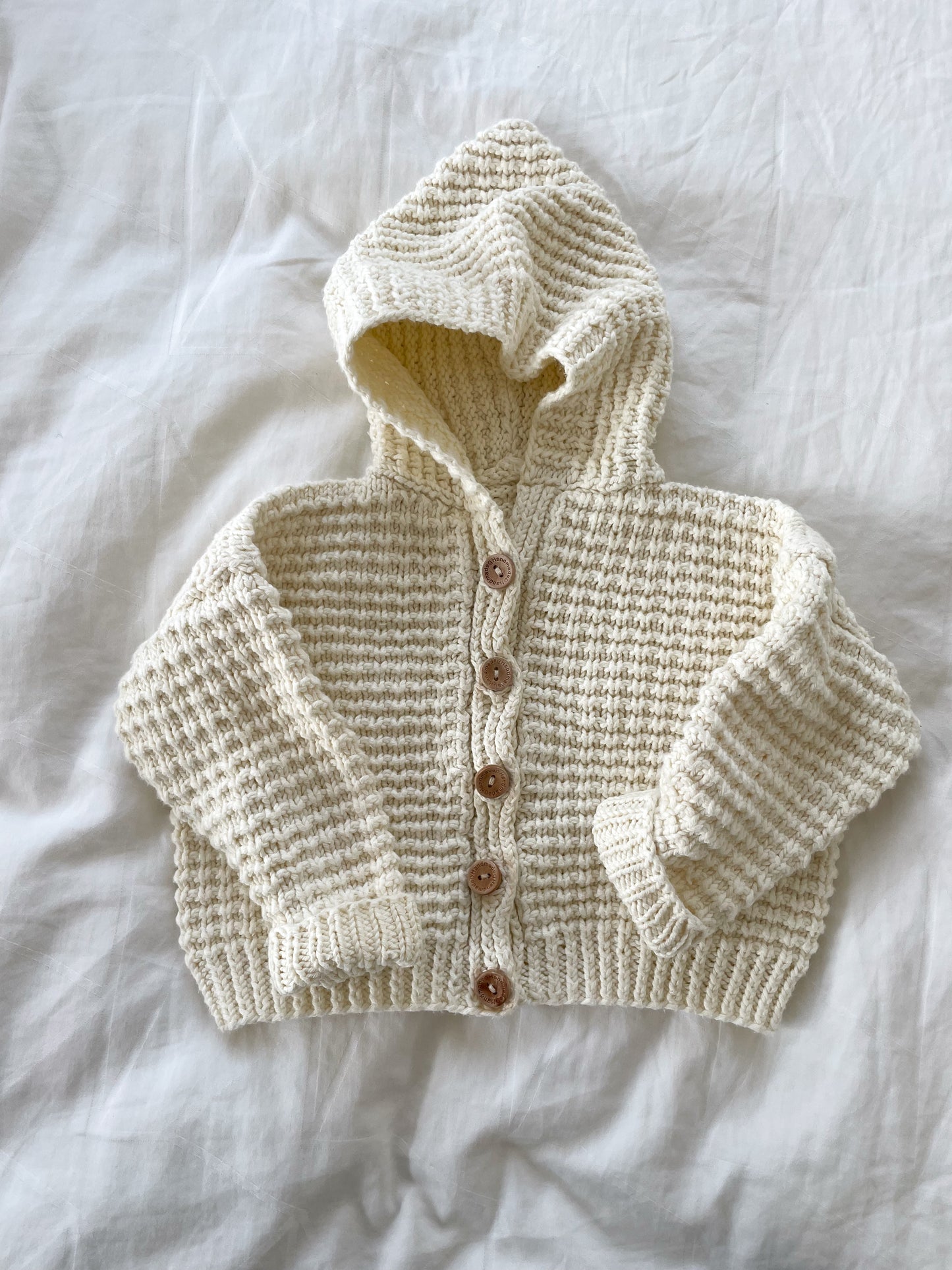 Håndstrikket cardigan med hætte